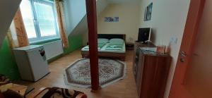 a room with a bedroom with a bed and a mirror at U Rozhovoru in Rovensko pod Troskami