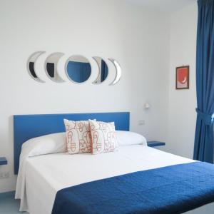 a bedroom with a bed with blue and white at Lena Magda B&B in Furore