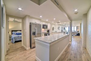 a kitchen with a counter top and a refrigerator at Waterfront Port Aransas Condo with Beach Access! in Port Aransas