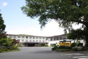 an empty parking lot in front of a building at Hotel Towadaso in Towada