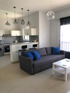 a living room with a couch and a kitchen at Waterside Apartments, El Gouna 1Bd plus Private Roof Terrace in Hurghada