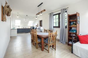a kitchen and dining room with a table and chairs at Wetlinowo in Wetlina