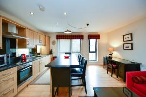 a kitchen with a island in the middle of a room at West Portland View Apartment A in Troon