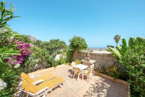 a patio with two chairs and a table and a table and chairs at Captivating 1-Bed House in Arona in Arona