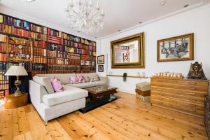 uma sala de estar com um sofá e um lustre em Sherlocks em Londres