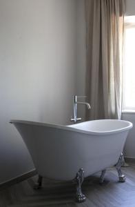a white bath tub in a bathroom with a window at Arbottna Herrgård AB in Muskö