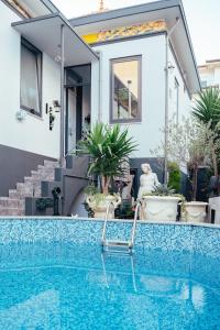 a house with a swimming pool in front of a house at alojamento maritimo II in Espinho