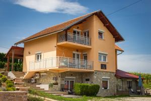 a large house with two balconies on it at Apartments Green Park in Rakovica