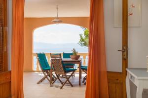 a dining room with a table and chairs and the ocean at Sa caleta des moixos in Alcudia