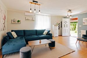 a living room with a blue couch and a table at Apartments Green Park in Rakovica