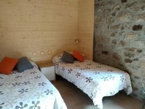 a bedroom with two beds and a wall with avertisement for at Abuela Eulalia in Maraña