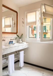 a bathroom with a sink and a mirror at Splendido Mare, A Belmond Hotel, Portofino in Portofino