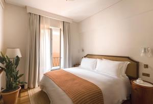 a bedroom with a large bed and a window at Splendido Mare, A Belmond Hotel, Portofino in Portofino
