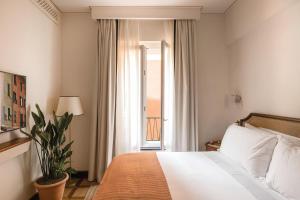 a hotel room with a bed and a window at Splendido Mare, A Belmond Hotel, Portofino in Portofino