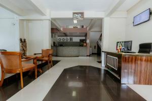 a living room with a wooden table and chairs at Panama Garden Resort in Moshi