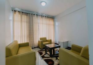 a living room with two couches and a table at Panama Garden Resort in Moshi +90 photos