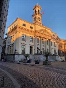 a building with a clock tower on top of it at BenB FirstClassEnglish in Dordrecht