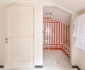 an open door in a room with red and white stripes at Splendido Mare, A Belmond Hotel, Portofino in Portofino