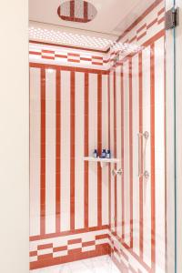 a bathroom with a shower with red and white stripes at Splendido Mare, A Belmond Hotel, Portofino in Portofino