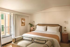 a bedroom with a large bed and a window at Splendido Mare, A Belmond Hotel, Portofino in Portofino