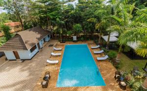 an overhead view of a swimming pool with lounge chairs and a resort at Panama Garden Resort in Moshi