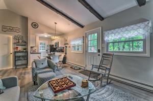 a living room with a table and chairs at Updated Blakeslee Cottage with Fire Pit and Deck! in Blakeslee