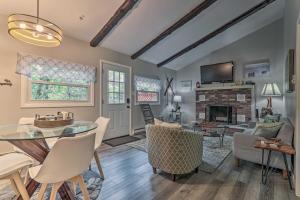 a living room with a table and chairs and a fireplace at Updated Blakeslee Cottage with Fire Pit and Deck! in Blakeslee