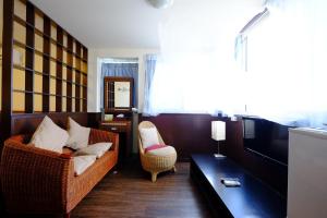 a living room with a couch and a table at Haiye Guest House in Kenting