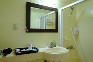 a bathroom with a sink and a mirror and a shower at Haiye Guest House in Kenting +16 photos