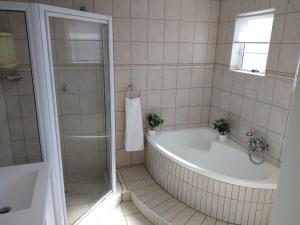 a bathroom with a bath tub and a shower at 20 on Beach Road in Swakopmund