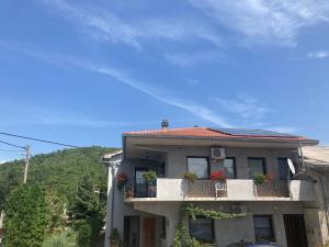 a house with a balcony with flowers on it at Guest house Sara in Rijeka
