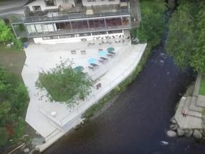 a building with a swimming pool next to a river at The Meetings B&B in Avoca