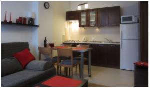 a kitchen with a couch and a table in a room at Unique Warsaw Center Apartment in Warsaw