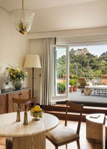 a living room with a table and chairs and a balcony at Splendido Mare, A Belmond Hotel, Portofino in Portofino
