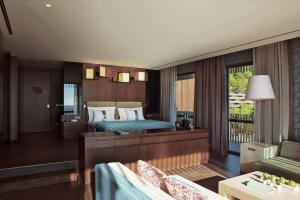 a bedroom with two beds and a living room at Maxx Royal Kemer Resort in Kemer