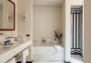 a white bathroom with two sinks and a mirror at Splendido Mare, A Belmond Hotel, Portofino in Portofino +37 photos