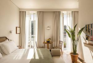 a hotel room with a bed and a window at Splendido Mare, A Belmond Hotel, Portofino in Portofino