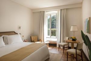 a hotel room with a bed and a window at Splendido Mare, A Belmond Hotel, Portofino in Portofino