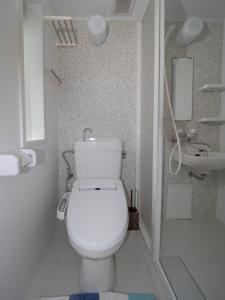 a white bathroom with a toilet and a sink at Kamakura International House Double Room w Shower Toilette - Vacation STAY 11408 in Kamakura