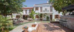 a large white building with a patio in front of it at Mellow Blue Hotel in İzmir