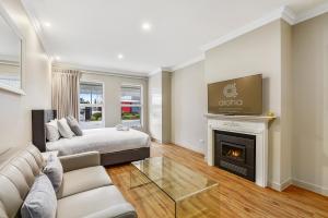 a living room with a bed and a fireplace at Aloha Central Luxury Accommodation in Naracoorte
