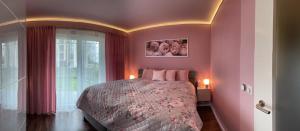 a bedroom with a large bed with pink walls at Krejcarek Garden Apartment in Prague