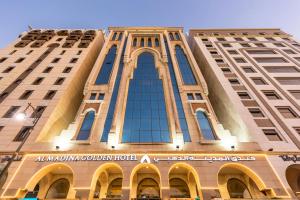 a building with a sign on the front of it at Al Madina Golden Hotel in Medina