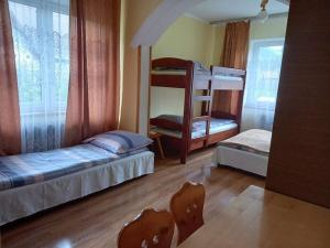 a bedroom with two bunk beds and a window at Ośrodek Agroturystyka "u Chlipały" in Ochotnica Górna +47 photos