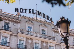 a hotel sign on the top of a building at Hotel Mora by MIJ in Madrid