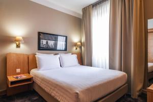 Postel nebo postele na pokoji v ubytování Le Grand Hotel