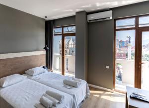 Postel nebo postele na pokoji v ubytování boulevard apartments