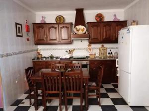 a kitchen with a table and a white refrigerator at Casa Quintas in Reguengos de Monsaraz
