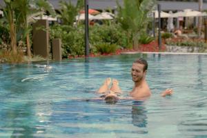 a man and a child swimming in a swimming pool at Liu Resorts in Side