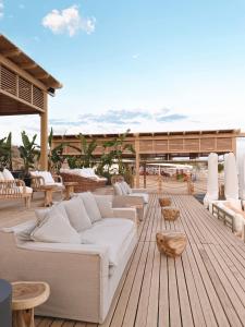 a living room with a white couch on a wooden deck at Liu Resorts in Side
